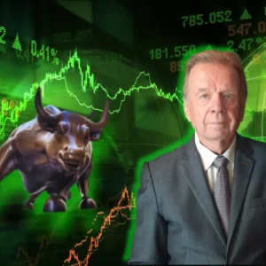 Kerry Grinkmeyer in a suit standing in front of a stock chart with a bull on it
